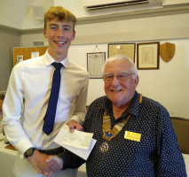 Will being presented with a cheque from Sport England (East) by Dunmow Rotary President Peter Watson.
